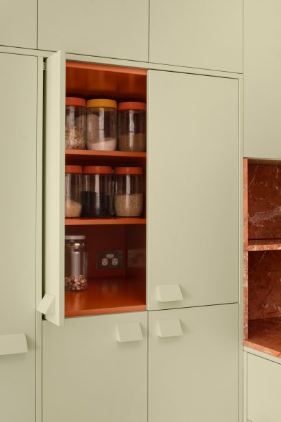 Pistachio green cabinets with red interior in mid-century renovation by Murray Barker and Esther Stewart
