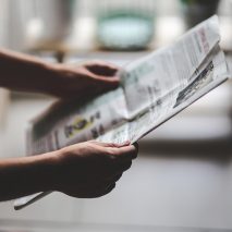 Man holding a newspaper to illustrate opinion about architecture critics