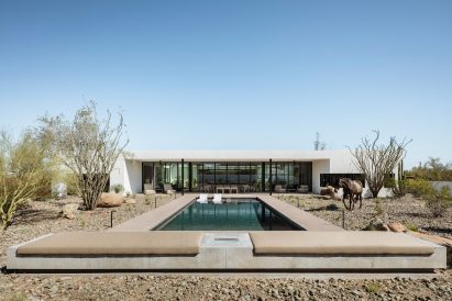 Concrete bench and firepit overlooking a swimming pool