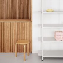 Wooden counter and white shelving in the OCE Copenhagen store interior by Aspekt Office