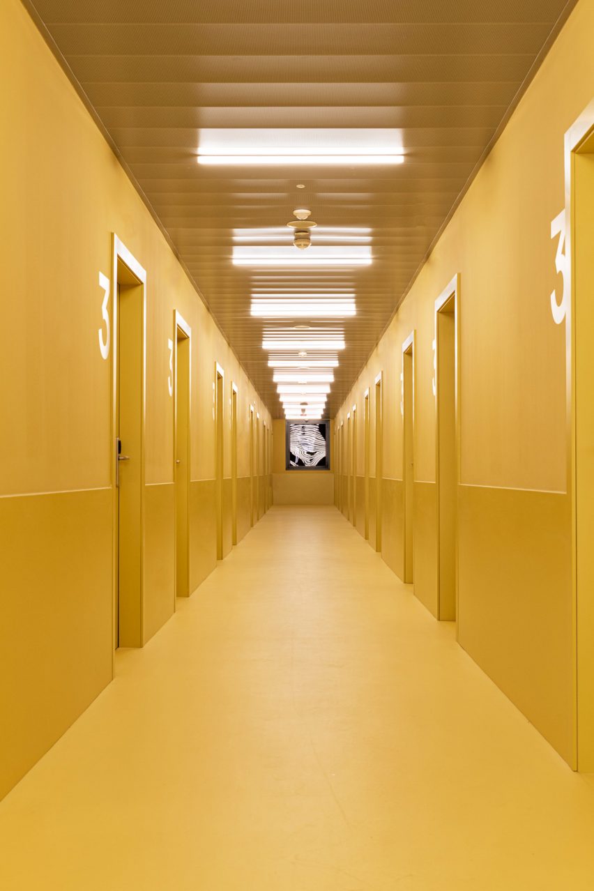 Yellow lines the walls and floor of the corridor