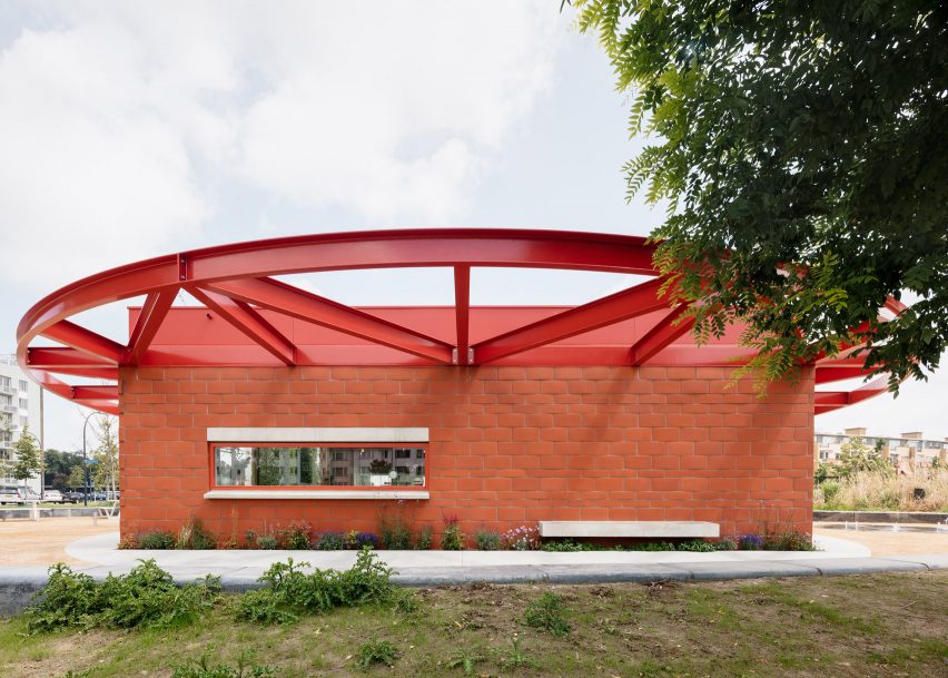 Red brick facade with red steel roof