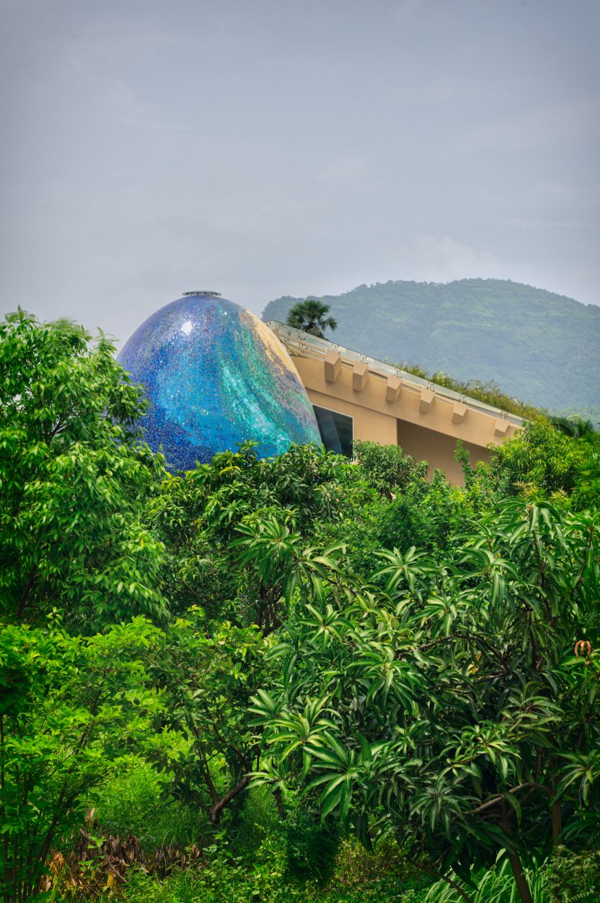 An egg-shaped temple outside an Indian house