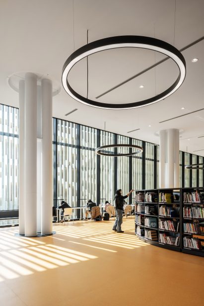 A double-height library with a bright yellow floor