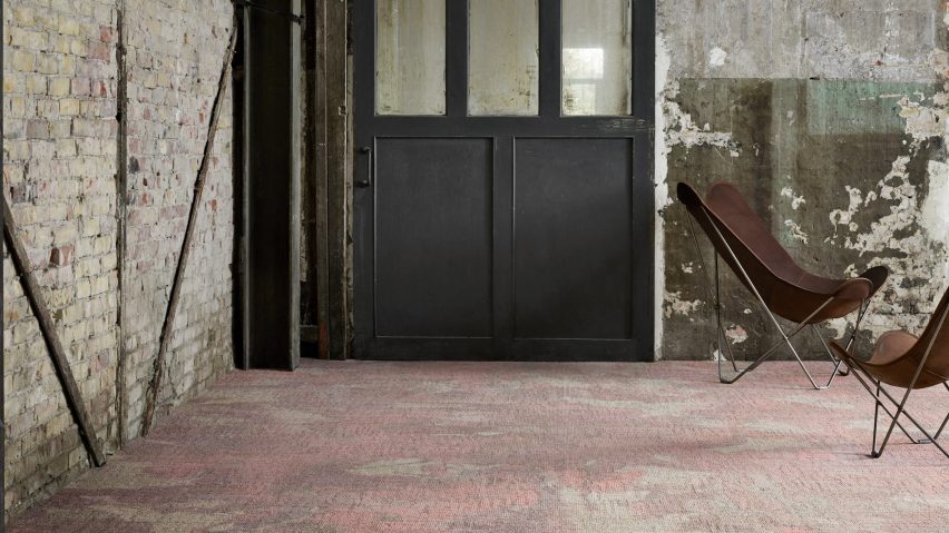 A red marble-look carpet in a brick building