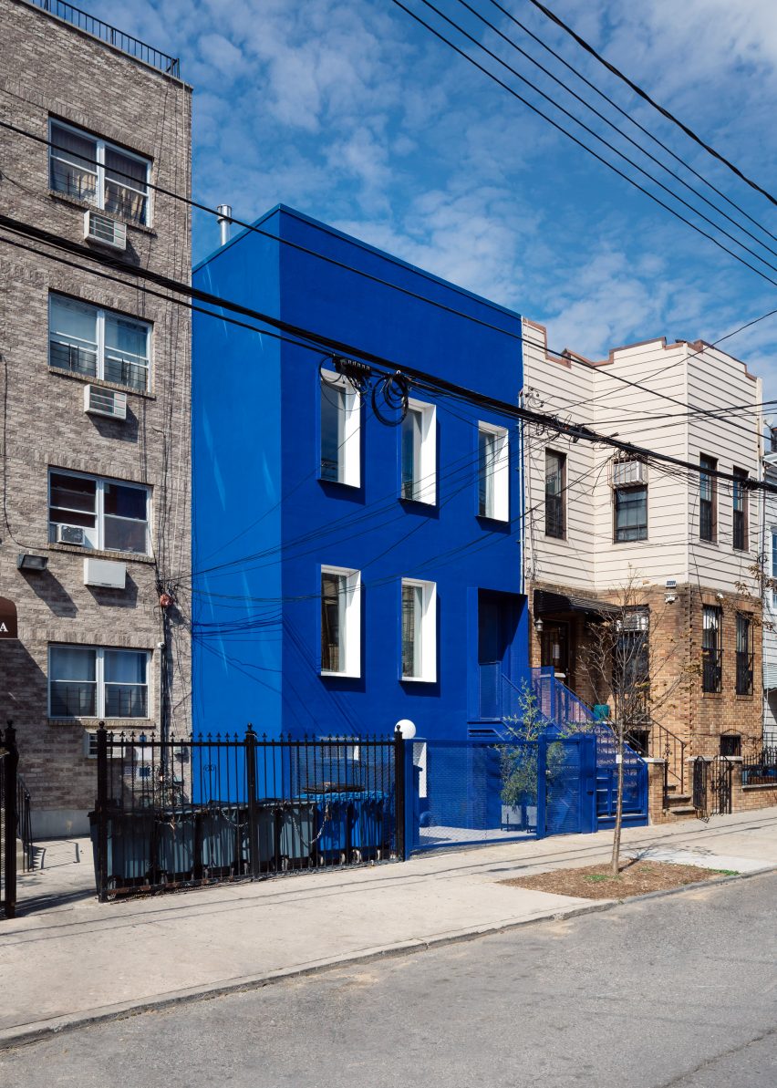 The Blue Building contrasts with the neutral properties on its street