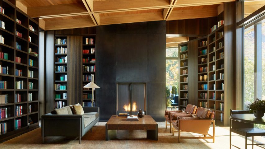 Tall built-in shelves and an open fire in living room