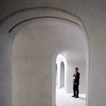 Portrait of Ma Yansong in a white-concrete building