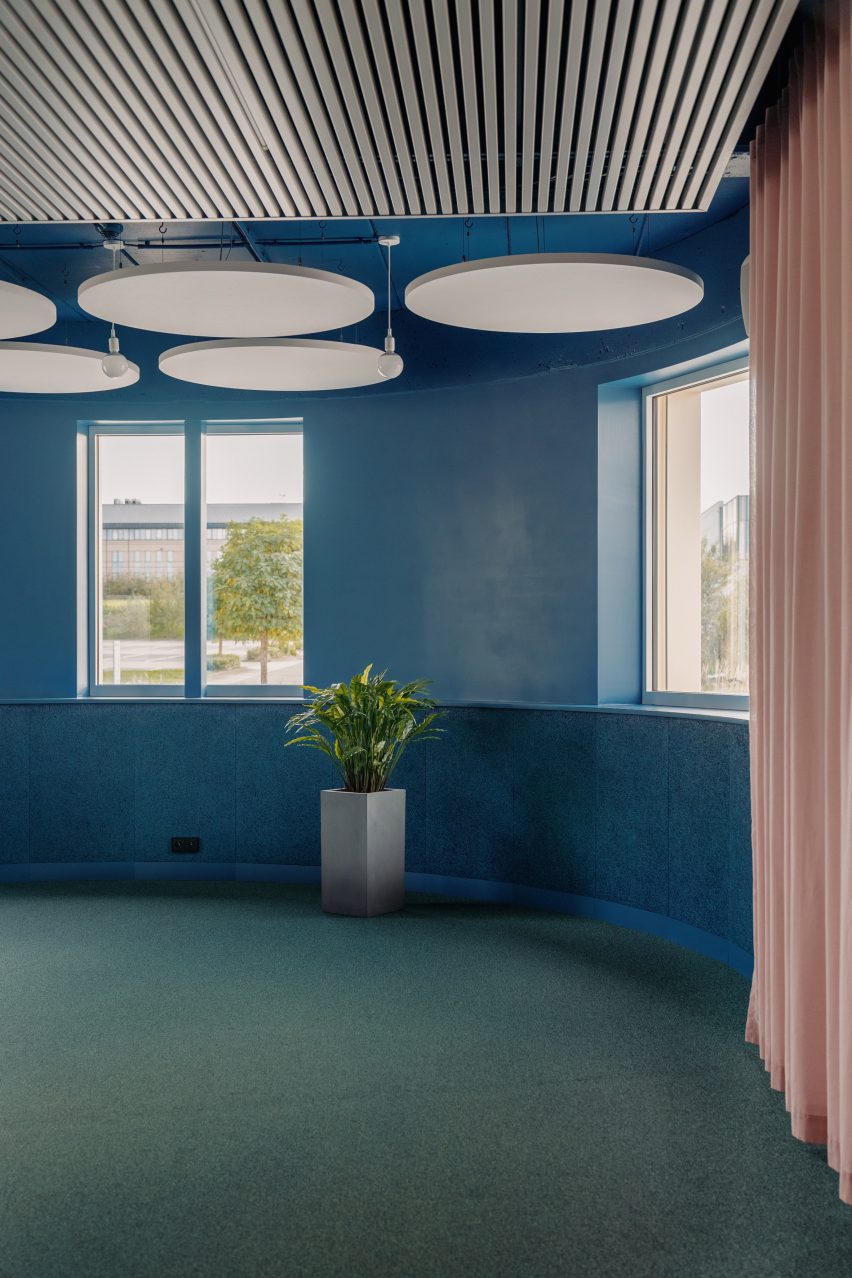 Circular acoustic panels run through the interior