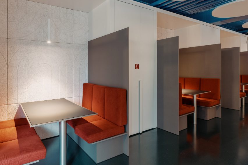 Seating in open plan spaces is upholstered in orange
