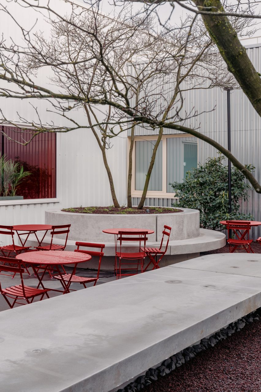 Red garden furniture fills the courtyard