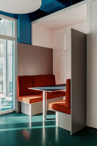 Chairs are upholstered in the company's orange