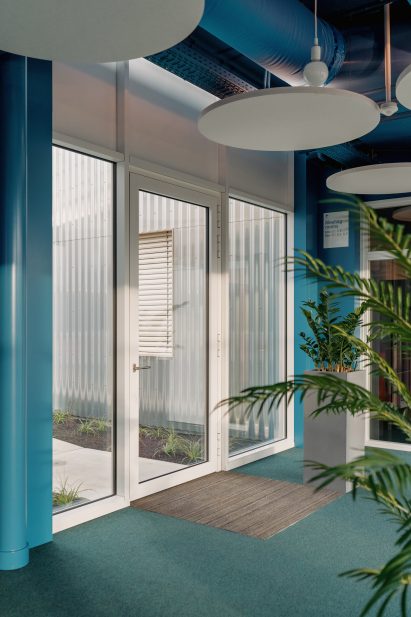 White framed doors and windows contrast against blue walls and carpet