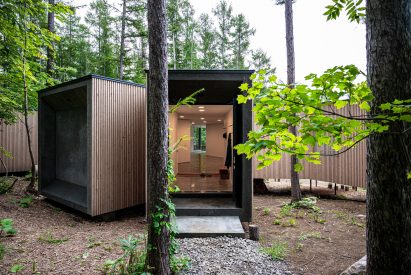 A concrete slab frames the entrance to the home by Florian Busch