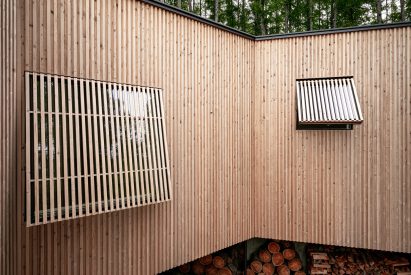 Wooden shade screens cover the windows by Florian Busch