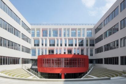 A circular red form sits atop a sunken courtyard