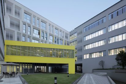 Yellow painted triangular form with slatted windows