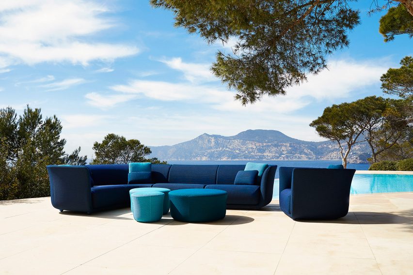 Curved modular sofa accompanied by lounge chair and pouffe