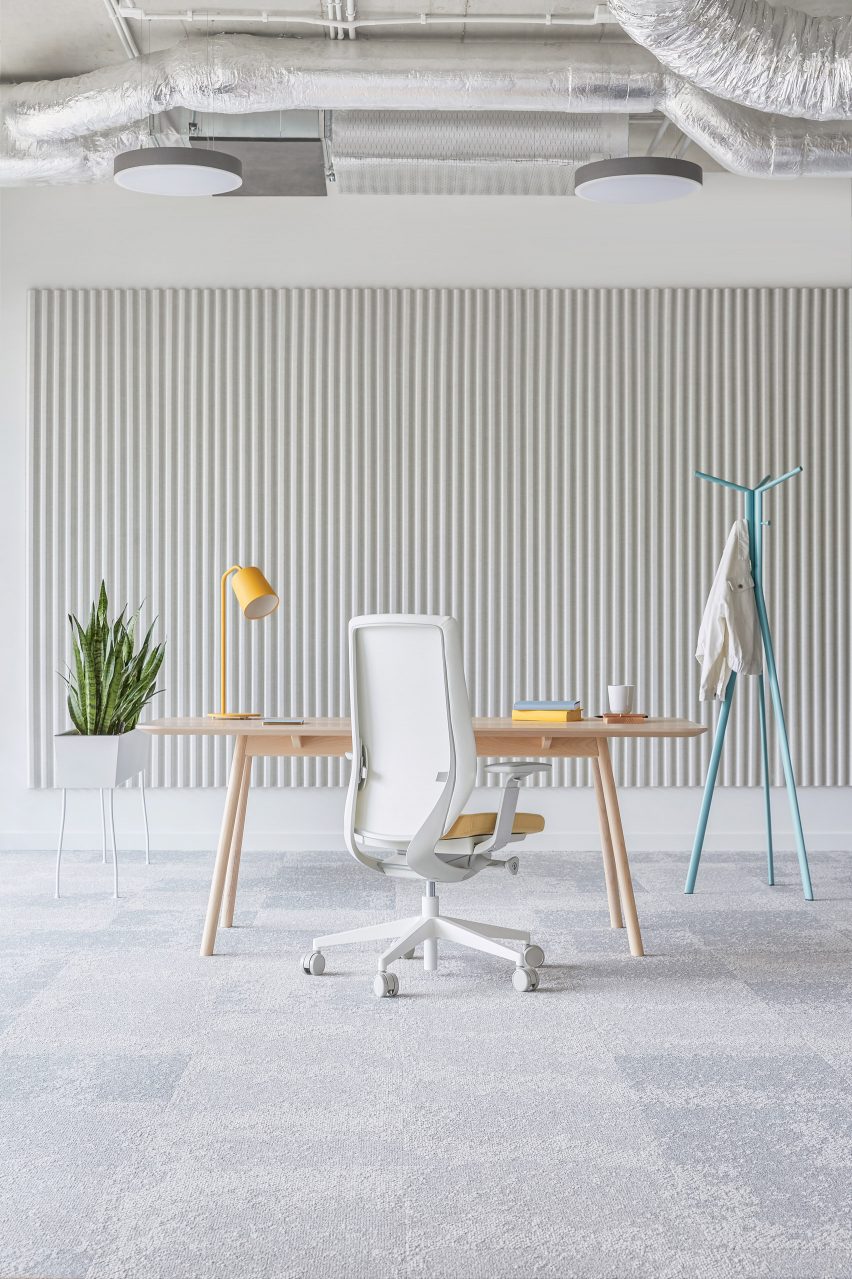 A grey office interior with a white office chair