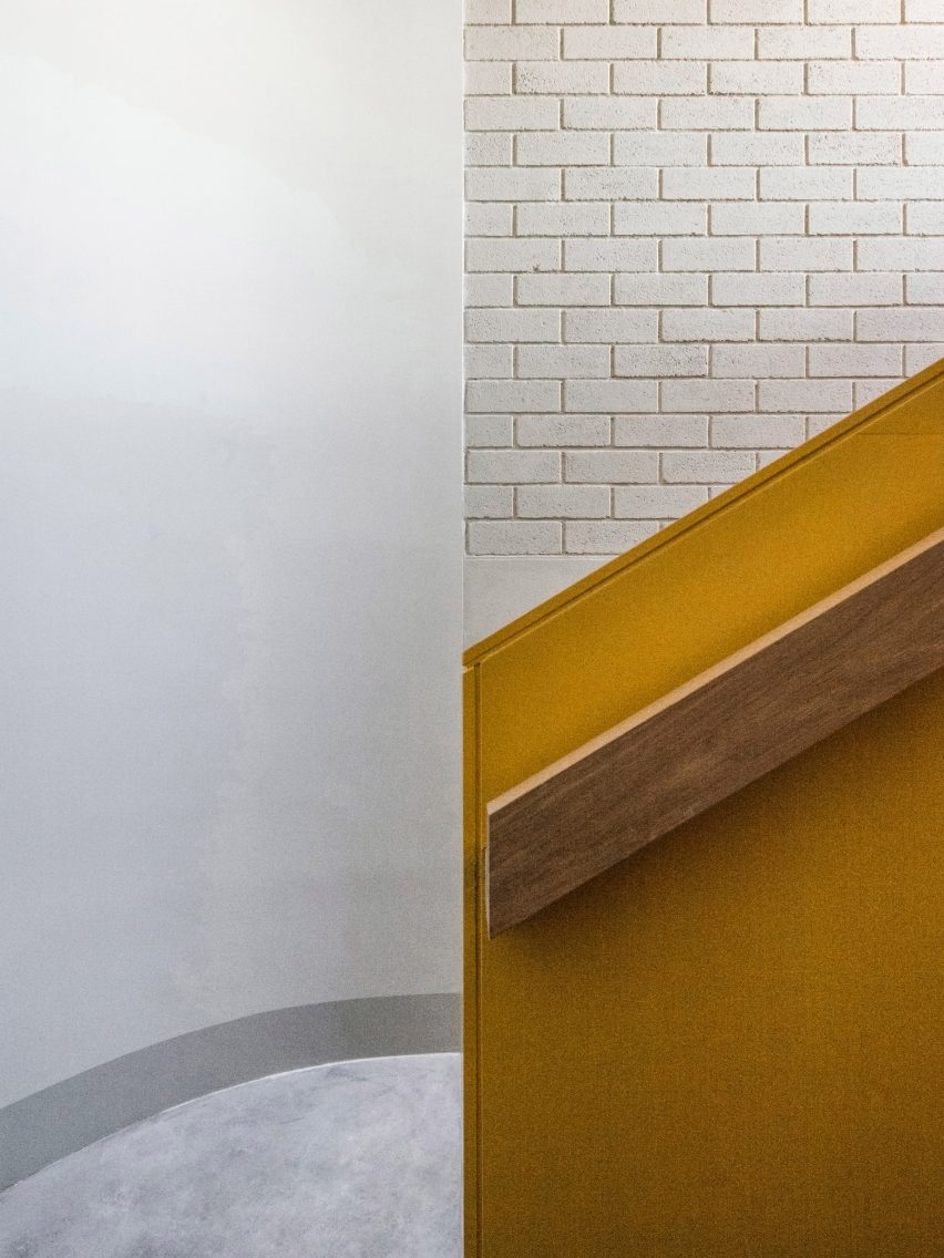 Stairwell has a tile and wood material palette