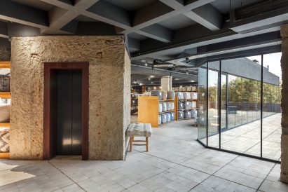 An elevator is covered with a rustic render