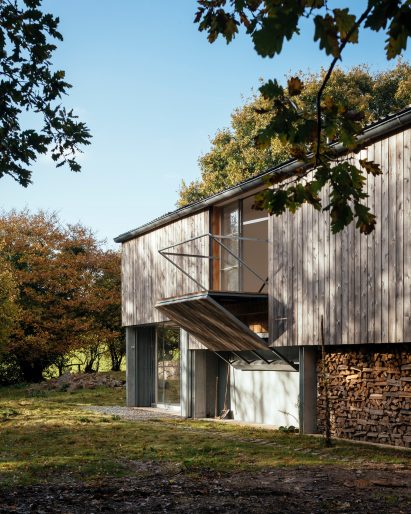 A converted barn with a folding balcony