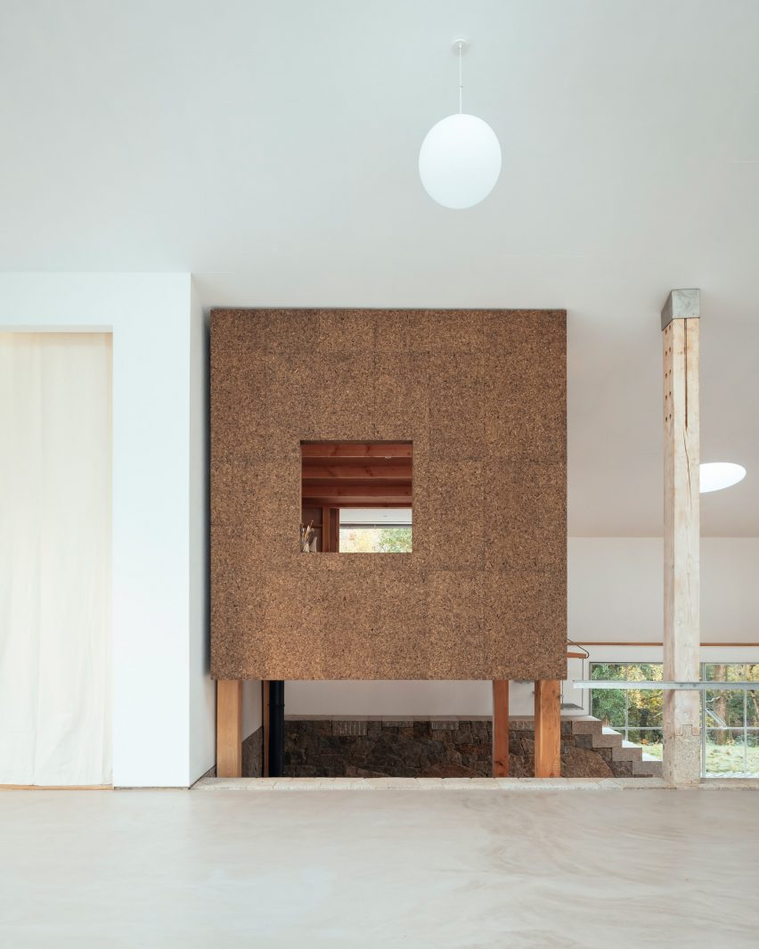 A white-walled studio and cork-clad room