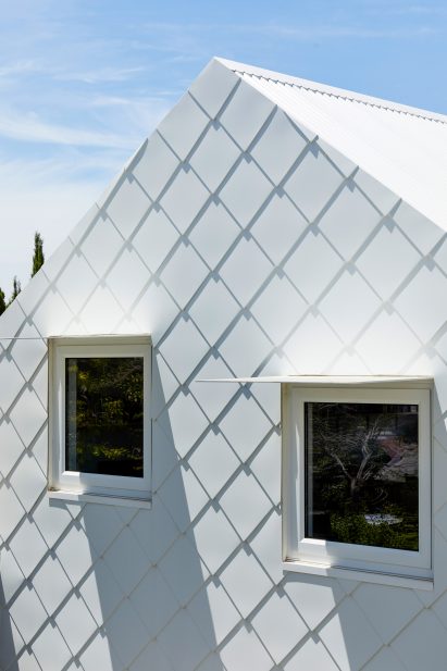 Windows have steel awnings by Austin Maynard Architects