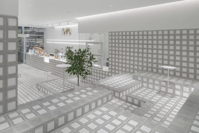 Grey and white seating area in cafe interior by Precht