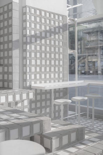 Grey and white brick wall and bar seating in % Arabica Bangkok location