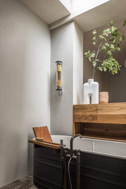 Free-standing black tin bath in bathroom