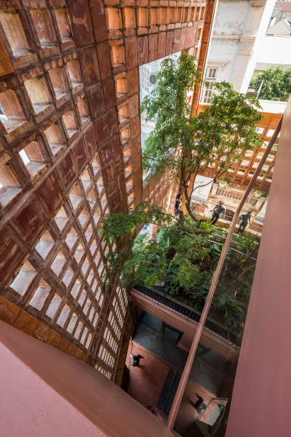 Gardens sit behind the ceramic wall by Vo Trong Nghia Architects