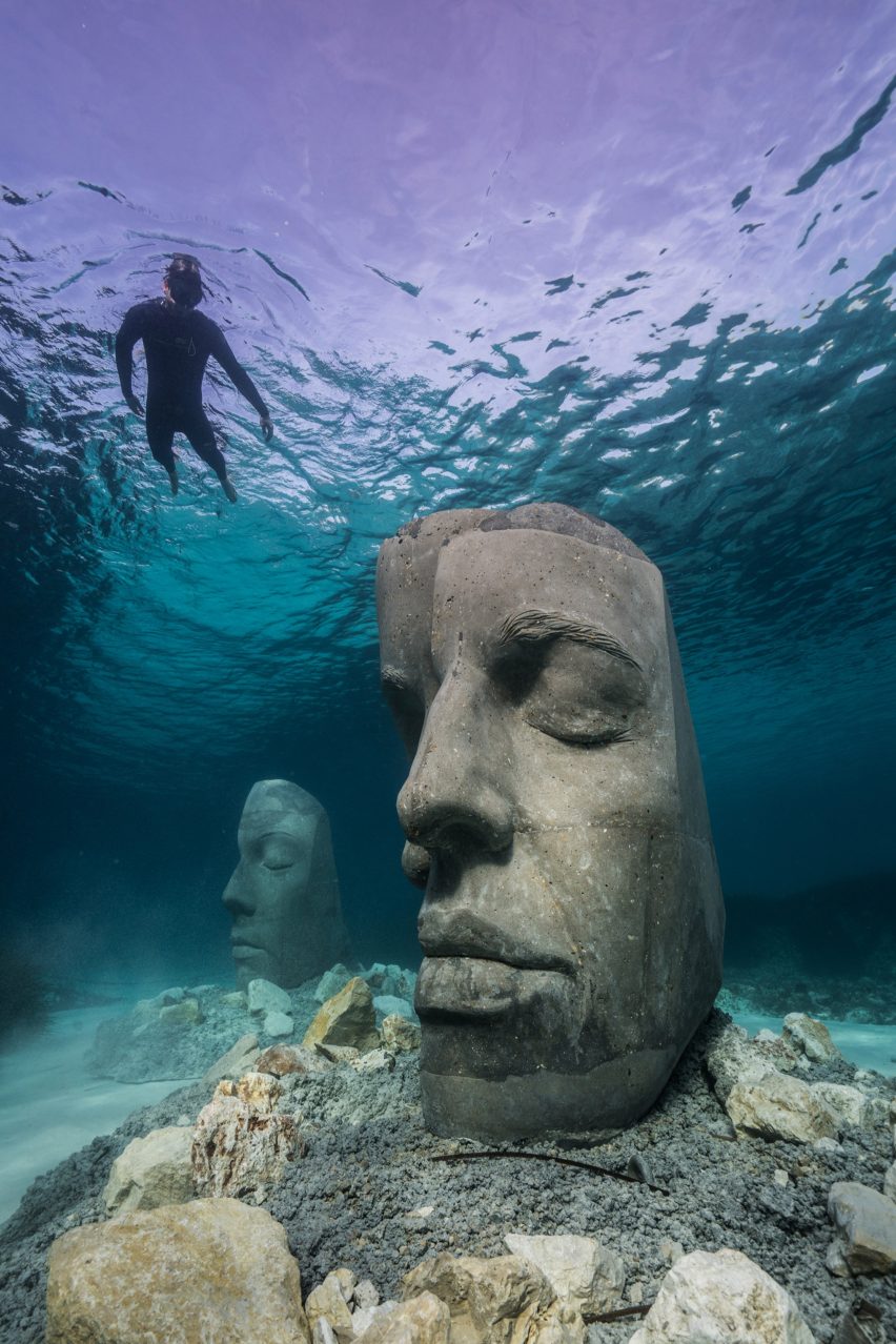 A snorkelers observing an underwater sculpture