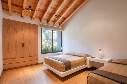 Exposed pine beams in a bedroom