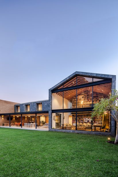 Casa Texcal by HGR Arquitectos has a grassy lawn