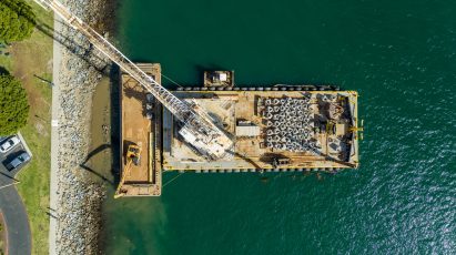A barge in San Diego Bay carrying man-made rock pools
