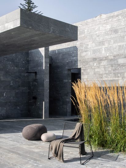 The entrance to a monolithic spa made from blocks of quartzite