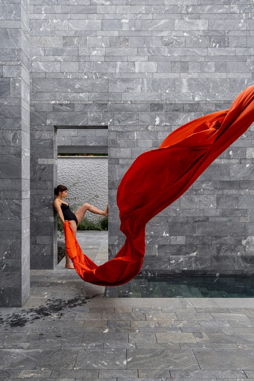 A model outside the stone exterior of a private spa in Austria