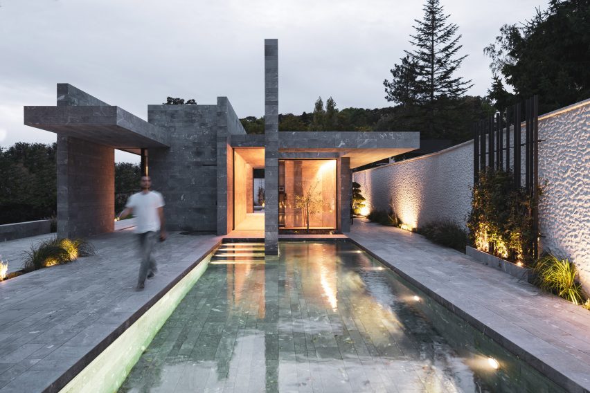 A swimming pool outside a private stone spa