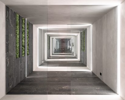 A subterranean corridor lined with stone slabs