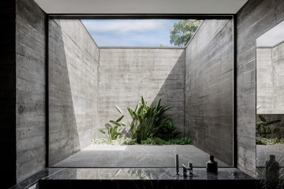 A courtyard enclosed by board-marked concrete