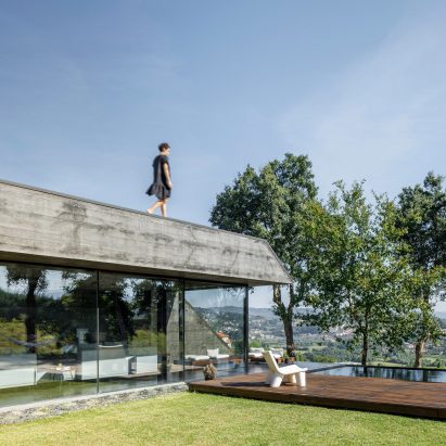 A hilltop concrete house with a roof terrace