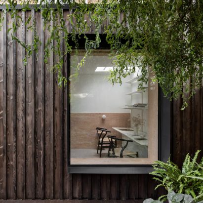 A charred-wood extension with a large window