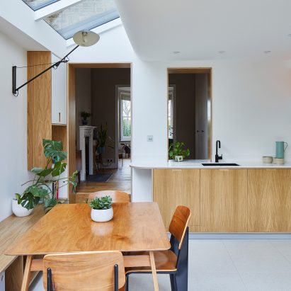 A white-walled kitchen with wooden furnishings