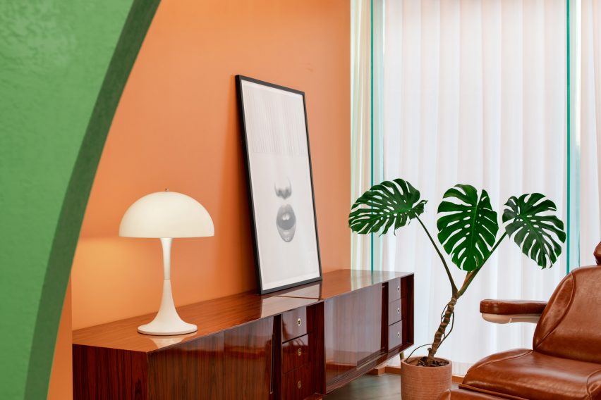Green walls contrasts with the orange