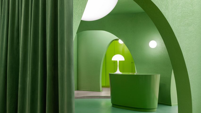 The space has green curtains and green furnishings