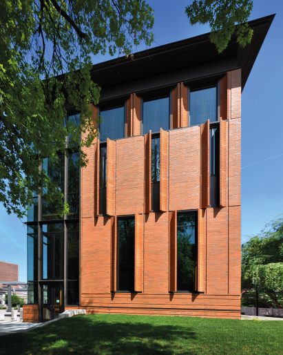A brick building with curved shutters