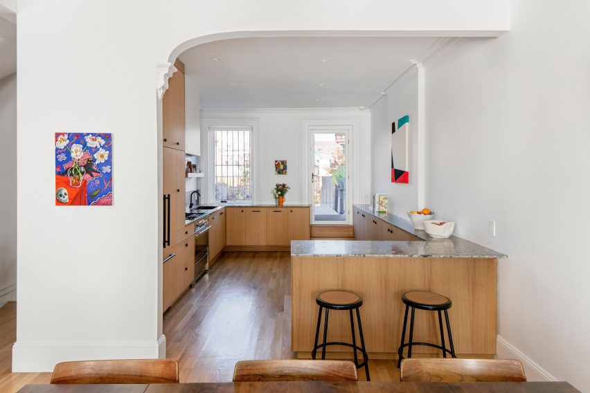 The kitchen has white oak floors