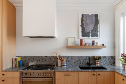 The kitchen features white oak cabinets