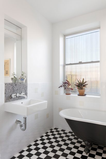 The bathroom has surplus cement tiles